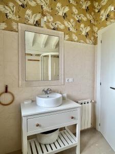 a bathroom with a sink and a mirror at Casa Nueva cerca del Mar en cala Berellin in Prellezo