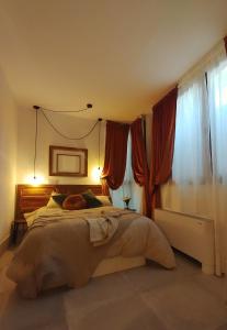 a bedroom with a large bed with red curtains at Arte i Espacio Home in Madrid +88 photos