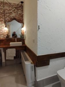 a bathroom with a sink and a mirror and a toilet at Arte i Espacio Home in Madrid