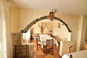 a dining room with a table and a stone wall at La Mitica in Ranca