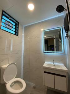 a bathroom with a white toilet and a sink at Brand New Premium House & Karaoke @BM Near Iconcity in Bukit Mertajam +31 photos