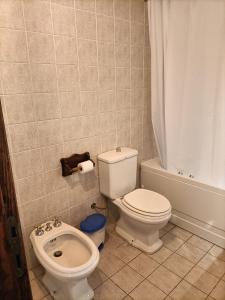 a bathroom with a toilet and a sink at Casa Pisani 21 in Iglesias