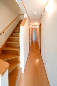 a staircase in a house with wooden floors at Villa Futaba若松町 in Hakodate