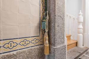a broom on the corner of a wall with a staircase at GuestReady - Comendador Sto Ildefonso - D in Porto