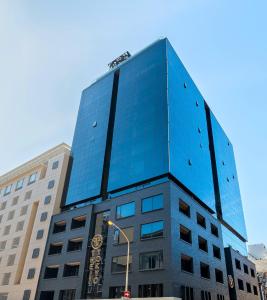 a tall blue building on a city street at The Tokyo Aparthotel by Totalstay in Cape Town