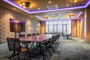 a conference room with a large table and chairs at NYX Hotel Hamburg by Leonardo Hotels in Hamburg