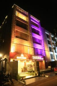 a building with purple and pink lights on it at Hotel Sakura by Maps in Gurgaon