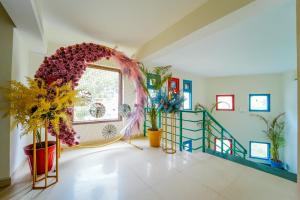 a living room with a large wreath on the wall at The Rose, Kasauli -A Four Star Lavish & Luxury Hotel in Kasauli