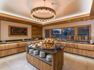 a large kitchen with a counter with food on it at Gasthof zur Post in Hinterriss