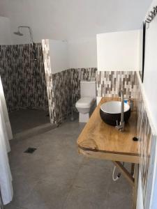 a bathroom with a sink and a shower and a toilet at Jua Manyara Lodge & Camp Site in Mto wa Mbu