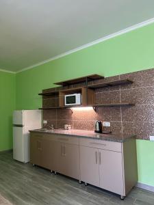 a kitchen with a counter and a refrigerator at Maestro in Ostroh