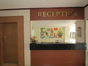 a reception room with a sign that reads reception at Hotel Subam in Palni +35 photos