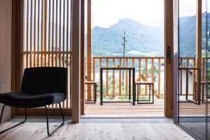 a black chair in a room with a balcony at TREMONDI - Boutique BnB in Quarten