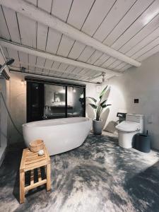 a large bathroom with a tub and a toilet at 嶼民宿 Yu Apartment in Jiufen