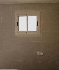 a bathroom with a window on the wall at Marina room in ‘Akko