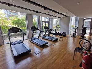 a gym with treadmills and elliptical machines at HiGuests - Colorful Apartment in Bluewaters Close to Beach in Dubai