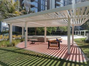 a pavilion with a bench and a picnic table at HiGuests - Colorful Apartment in Bluewaters Close to Beach in Dubai