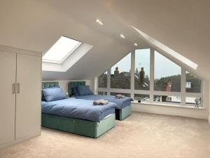 a bedroom with a bed and a large window at The View in Leeds