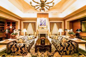 a large living room with couches and a chandelier at Hotel Hankyu International in Osaka