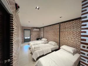 a room with four beds and a brick wall at Bayfront608 in Ban Khlong Dan +126 photos