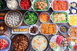 a table with many different types of food in bowls at ART Hotel Oita in Oita