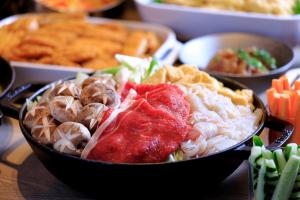 a bowl of noodles and other foods on a table at ART Hotel Oita in Oita