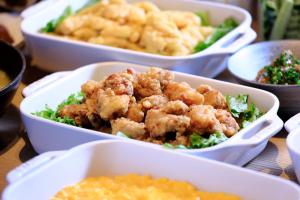 a table topped with four white dishes of food at ART Hotel Oita in Oita