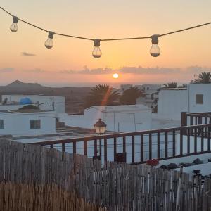 a view of the sunset from a balcony with lights at Sunset house in Soo