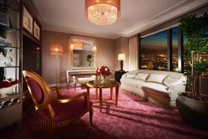 a living room with a bed and a large window at Hotel Hankyu International in Osaka