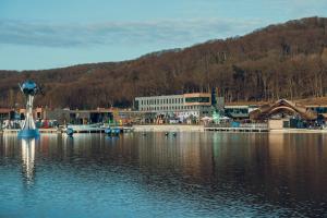 a view of a body of water with a building at Emily Magic Hostel in Vynnyky