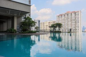 a large pool of water next to some buildings at 15 min to KL Pavillion & Beautiful Scenery By Nexx Field in Kuala Lumpur