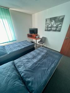 A bed or beds in a room at Hotel CAVOK letiště Příbram