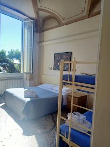 a bedroom with two bunk beds and a window at Hotel Serena in Arenzano