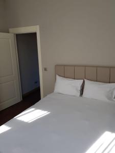 a bed with white pillows in a bedroom at Eleven Aparts in Istanbul