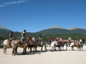 a group of people riding horses on the beach at Agriturismo Maneggio Vallecupa in Pescasseroli +29 photos