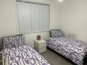 a bedroom with two beds and a window at Calm house twin beds in Wyken