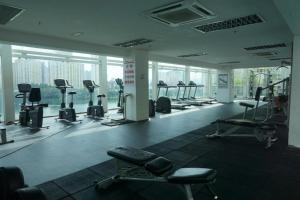 a gym with treadmills and machines in a building at Romance in de house 3-5pax Two Parking Free, There is a shopping mall downstairs in Kuala Lumpur