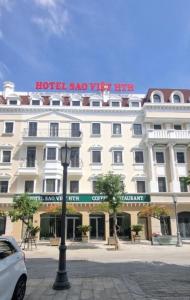 a hotel with a sign on top of a building at Sao Việt HTH Hotel in Ha Long