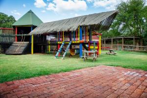 a playground with a slide and a play structure at Sondela Nature Reserve & Spa Chalets in Bela-Bela