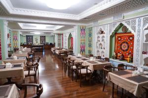 a restaurant with tables and chairs in a room at Sangzor Boutique Hotel in Samarkand