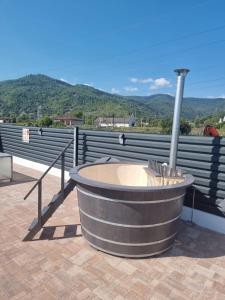 un bain à remous sur un toit avec des montagnes en arrière-plan dans l'établissement Vila Lorena, à Stejaru