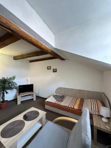 a living room with a bed and a couch at Hotel U Radnice Aš in Aš