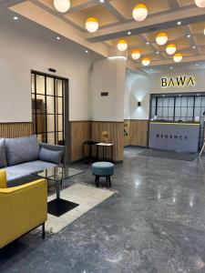 a lobby with a couch and a table at Hotel Bawa Regency in Mumbai