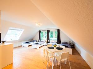 a living room with a table and chairs in a attic at Apartment in Trappenkamp near Kiel in Trappenkamp