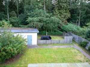 a backyard with a fence and a shed at Apartment in Trappenkamp near Kiel in Trappenkamp