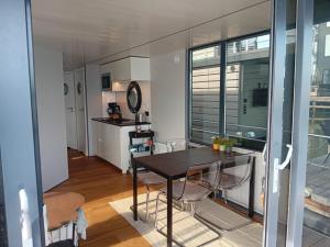 a kitchen and dining room with a table and chairs at MOLLÖSUND - Hausboot im Herzen von Göteborg in Gothenburg