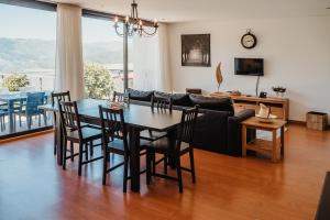 a living room with a table and a couch at Encosta de Louredo by Pousadela Village in Vieira do Minho