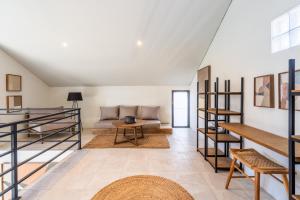 a living room with a couch and a table at Ambara Residence Villa in Canggu