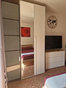 a mirror in a bedroom with a bed and a television at CorneliaGuestHouse in Rome