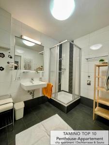a bathroom with a shower and a sink at Penthouse TAMINO TOP 10 in Schladming